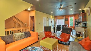 A spacious living area with a sofa, chairs, a coffee table, and a ceiling fan. - Urban Escape w/ Patio - 2 Mi to Downtown Detroit! (Detroit)
