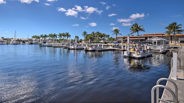 A marina with boats docked, palm trees, and a clear blue sky. - Studio w/ Marina Views: 15 Mi To Everglades! (Naples)