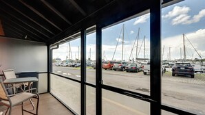 A balcony with a view of a marina and parked cars. - Studio w/ Marina Views: 15 Mi To Everglades! (Naples)