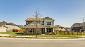 A two-story house with a stone facade, a front porch, and a garage. - Nolensville Home w/ Free Wifi: 20 Mi to Nashville! (Nolensville)