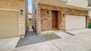 A residential building with a stone facade, a wooden door, and a garage. - Houston Vacation Rental ~ 1 Mi to Downtown! (Houston)