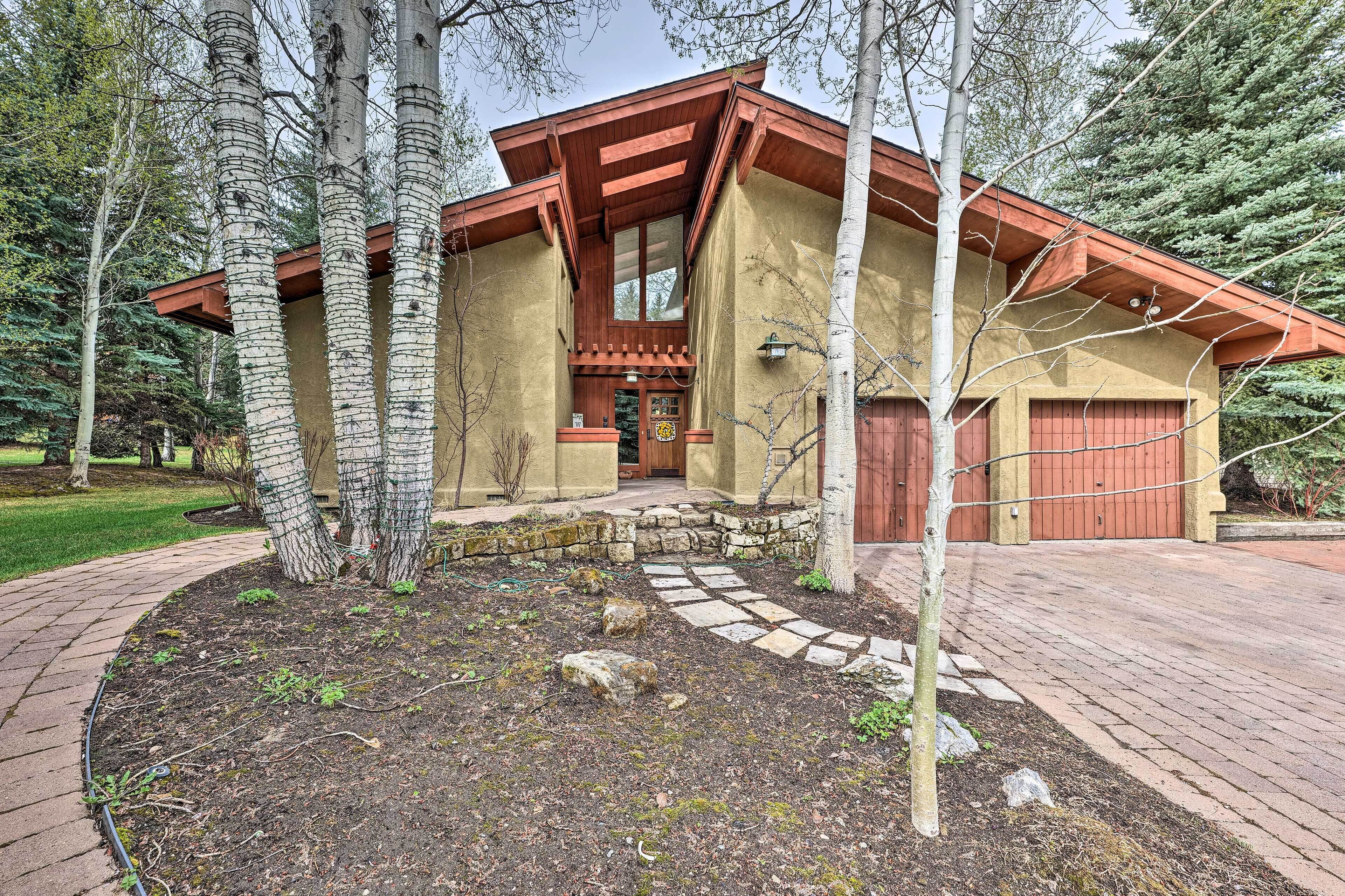 A rustic building with a stone foundation, wooden beams, and a red roof.