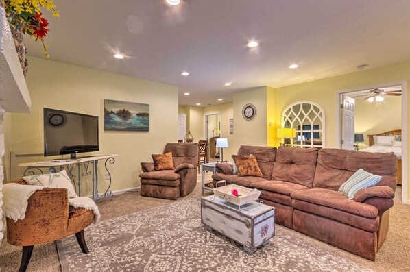 A living room with two brown sofas, a coffee table, and a TV.