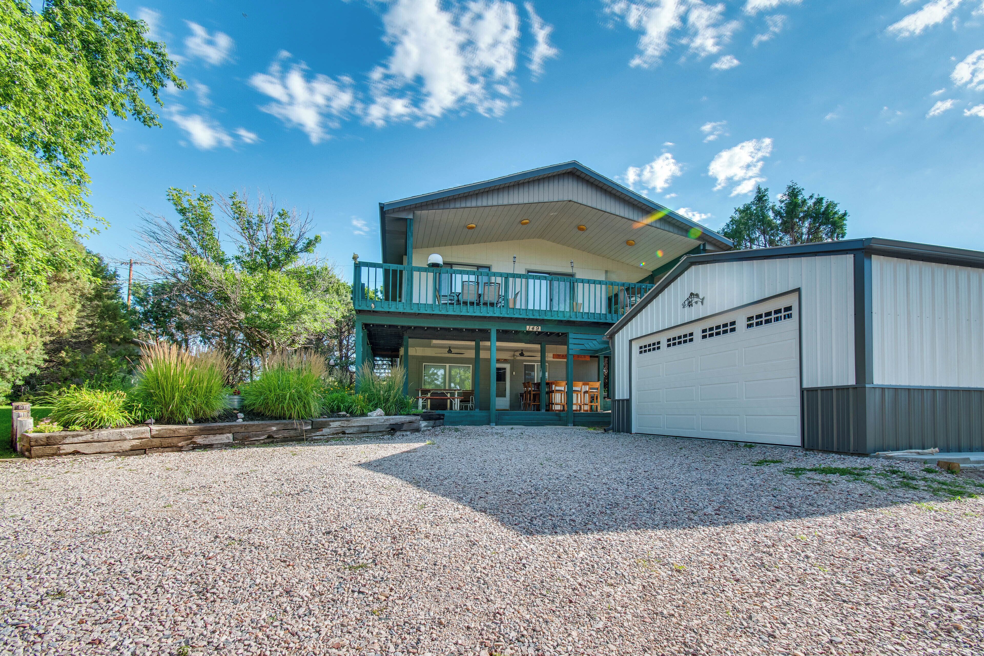 A two-story building with a covered patio and a garage.
