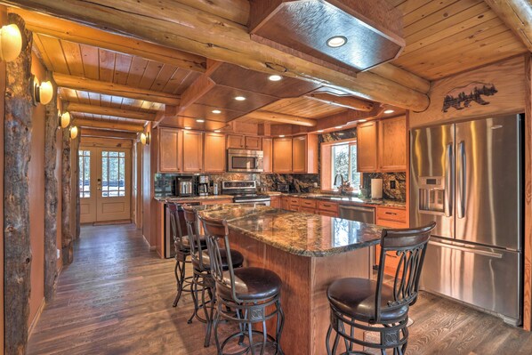 A spacious kitchen with a large island, stainless steel appliances, and wooden cabinetry. - Cascade Cabin w/ Mountain View & River Access (Cascade)