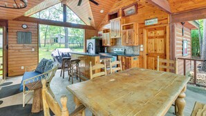 A wooden cabin with a dining area, kitchen, and seating area. - 'cape Royale' Luxury Livingston Cabin w/ Hot Tub! (Coldspring)