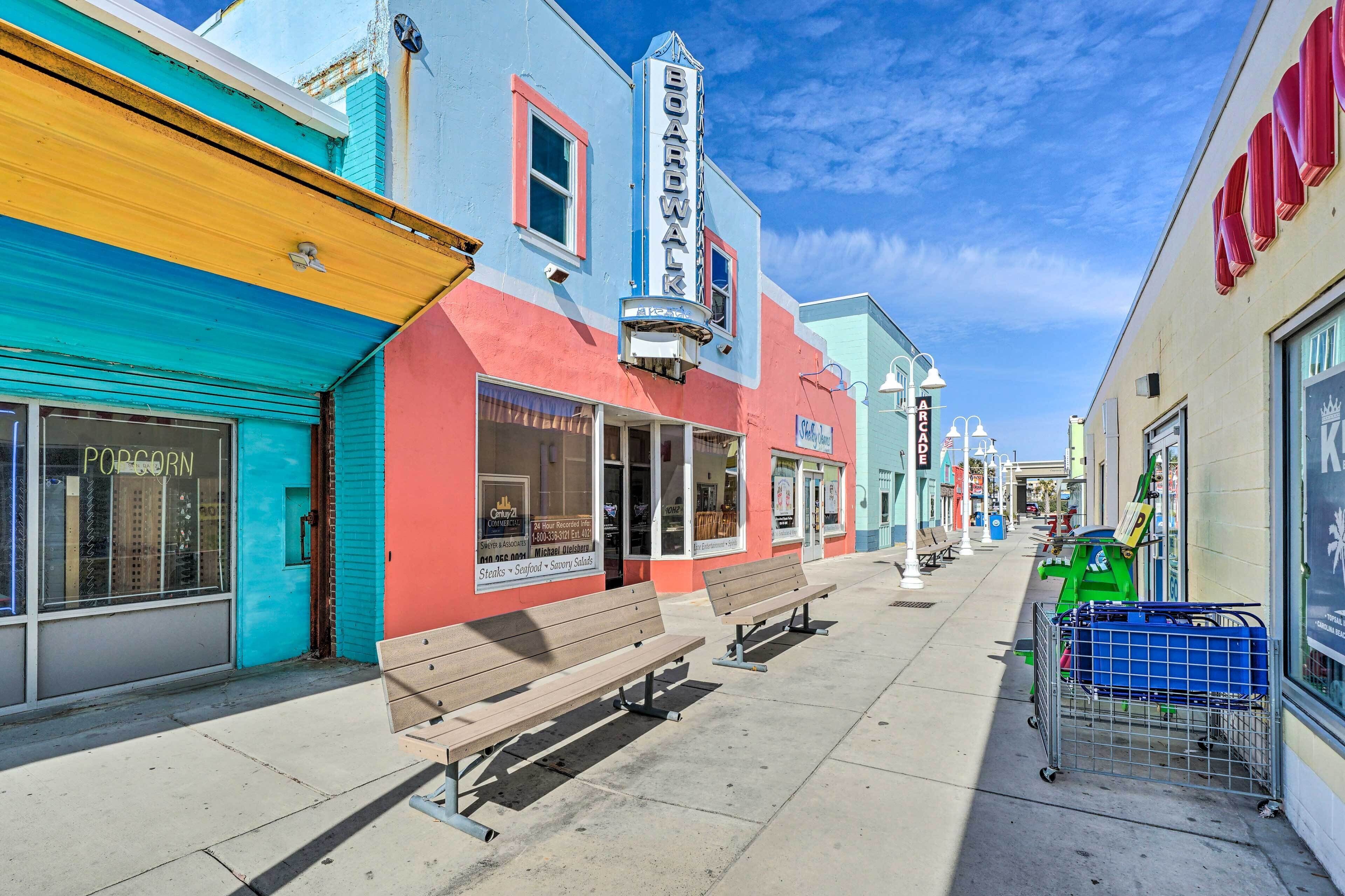A sidewalk with a bench, storefronts, and a shopping cart.