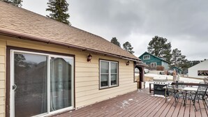 A house with a sliding glass door, a deck with outdoor furniture, and a barbecue grill. - Mtn-view Home w/ Deck, 2 Mi to Mickelson Trail! (Lead)