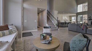 A spacious living area with a staircase, a dining area, and a kitchen. - Spacious La Verkin Home: Near Zion Nat'l Park (La Verkin)