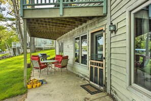 A covered patio with outdoor furniture and potted plants. - Lakefront Glen Arbor Condo w/ Boat Dock Access! (Glen Arbor)