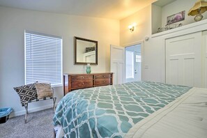 A bedroom with a bed, dresser, mirror, and a door leading to another room. - Cozy Darrington Cottage w/ Grill, Near Trails (Darrington)