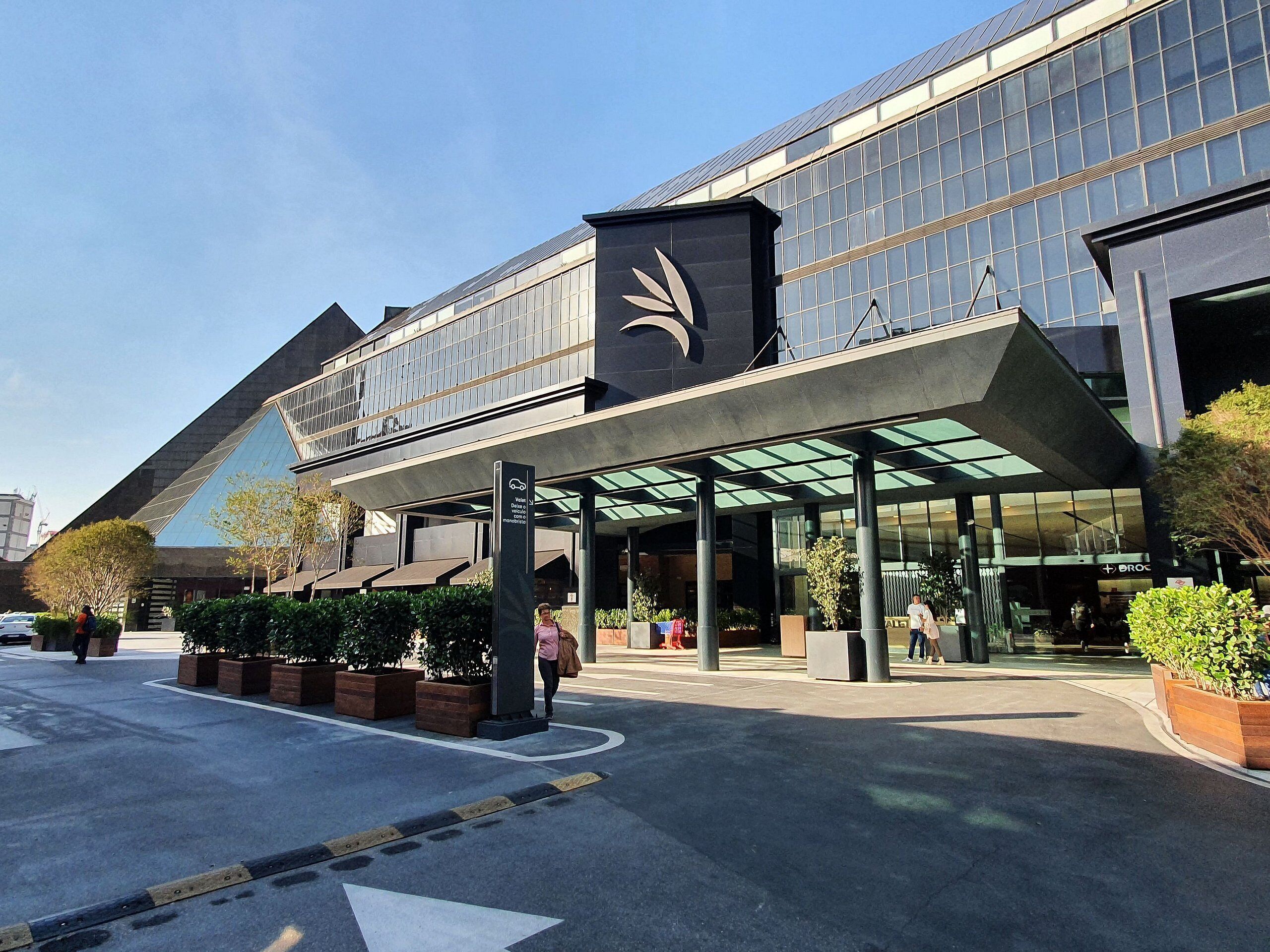 A modern building with a glass facade and a distinctive logo on the entrance.