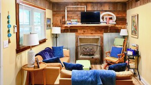 A cozy living room with a fireplace, a television, and comfortable seating. - Rustic Hideaway w/ Fire Pit < 1 Mi to River! (Hillsboro)