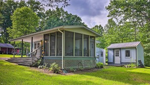 A small, single-story house with a porch and a screened-in area. - Rustic Hideaway w/ Fire Pit < 1 Mi to River! (Hillsboro)