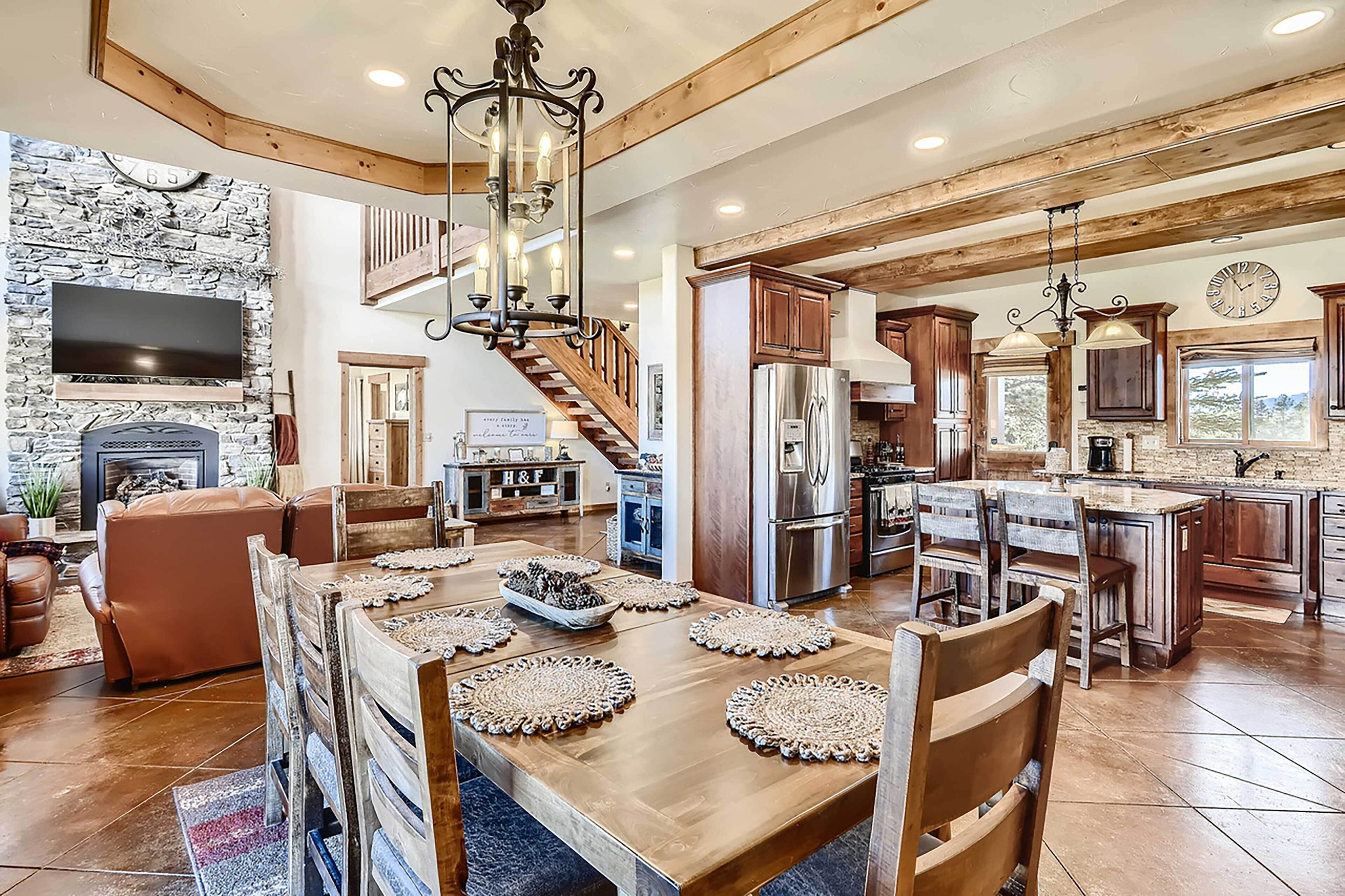 A spacious kitchen with wooden cabinets, a large island, and a built-in refrigerator.