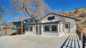 A modern house with a large patio area, a garage, and a fenced yard. - Updated Buffalo Springs House on the Lake! (Lubbock)