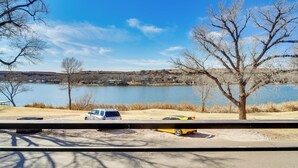 A view of a lake with parked cars and leafless trees. - Updated Buffalo Springs House on the Lake! (Lubbock)