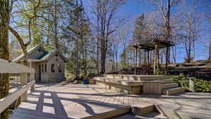 A wooden deck with steps leading to a gazebo, surrounded by trees. - Cozy Log Cabin: 6 Mi to Great Smoky Mtns NP! (Townsend)