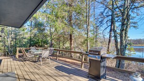 A wooden deck with a grill and seating area overlooking a lake. - Near Skiing: Lakefront Gem w/ Kayaks in Long Pond (Long Pond)
