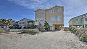 A two-story building with a gravel driveway and a well-maintained garden.