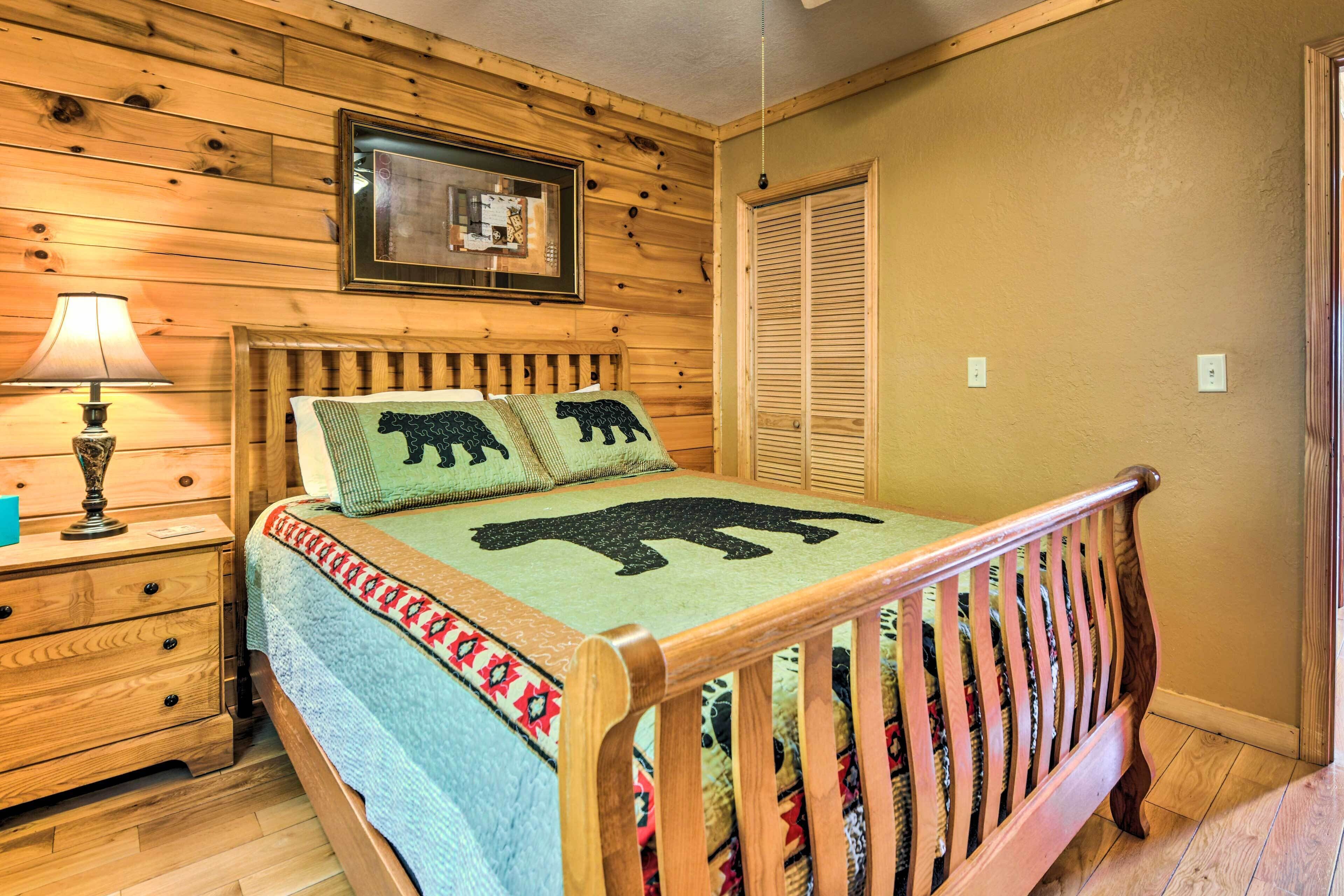 A wooden-paneled bedroom with a bed, a nightstand, a lamp, and a closet.