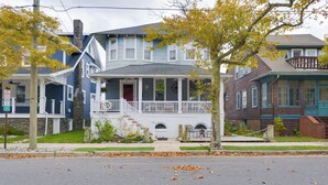 A two-story house with a porch and a small front yard. - Cozy Ventnor Getaway: Walk to Public Beach! (Ventnor City)