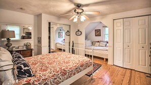 A bedroom with a bed, a ceiling fan, a nightstand, a lamp, and a wardrobe. - Spacious Faber Home w/ Yard, Steps to Winery! (Faber)