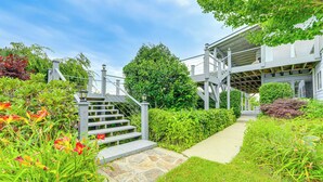 A staircase leading to a house with a garden and a covered walkway. - North Carolina Vacation Rental w/ Fire Pit & Grill (Leicester)