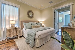 A bedroom with a bed, nightstands, a mirror, and a plant. - Beach Oasis w/ Pool Access, ~ 1 Mi to Shore! (Santa Rosa Beach)