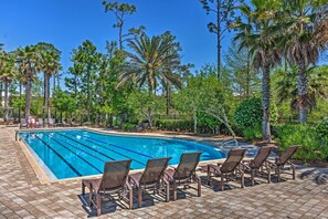 A swimming pool with lounge chairs and palm trees. - Beach Oasis w/ Pool Access, ~ 1 Mi to Shore! (Santa Rosa Beach)