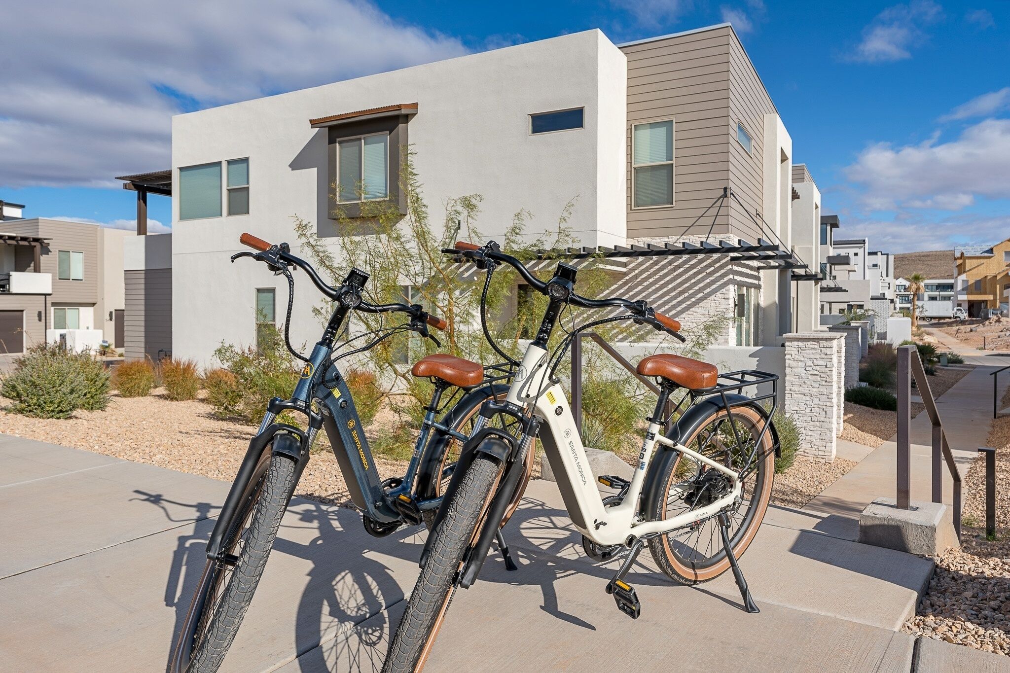 A modern building with two bicycles parked in front.