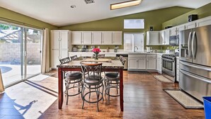 A spacious kitchen with a dining area, large windows, and modern appliances. - Incredible Wildomar Getaway w/ Outdoor Oasis! (Wildomar)