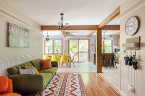 Relax in this inviting living area with a sofa, dining table, and kitchen bar.