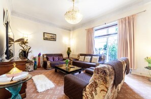 Relax in a stylish living room with a comfortable sofa set, armchairs, and a coffee table.