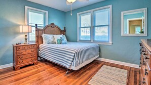 A bedroom with a bed, dresser, nightstand, and a ceiling fan. - Modern Seaview House - 200 Yards to Daytona Beach! (Daytona Beach)