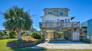 A two-story house with a covered porch and a basketball hoop. - Spacious North Topsail Family Home With 2 Decks (Sneads Ferry)