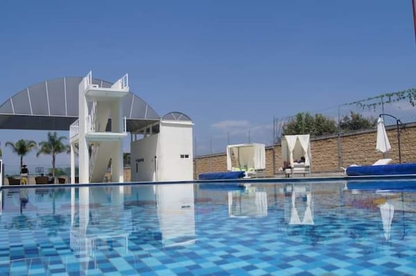 Outdoor pool, open 7:00 AM to 8:00 PM, pool umbrellas, pool loungers
