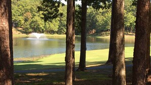 A golf course with a pond and trees. - Furnished Deck & Grill: Hot Springs House (Hot Springs Village)