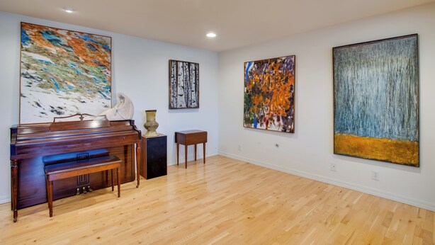 A spacious room with a grand piano, wooden flooring, and three large abstract paintings on the walls. - Grand Junction Abode ~ 2 Miles to Wineries & Golf! (Grand Junction)