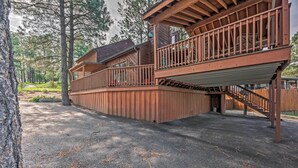 A wooden cabin with a deck and stairs leading to a second level. - Cozy Ruidoso Cabin w/ Private Hot Tub & Large Deck (Ruidoso)