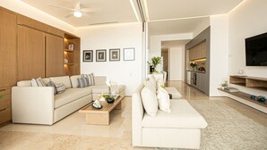 A modern living room with a sofa, coffee table, and a TV.