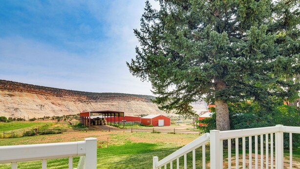 A rural landscape with a barn, a large tree, and a white fence. - Ranch House in Boulder! Gateway to Nearby Parks! (Boulder)