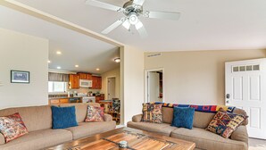 A living room with two sofas, a coffee table, and a ceiling fan. - Ranch House in Boulder! Gateway to Nearby Parks! (Boulder)