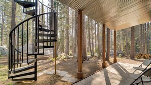 A spiral staircase leading to a covered outdoor area with a patio and chairs. - Kid/pet Friendly! Close to Sugar Bowl! (Soda Springs)