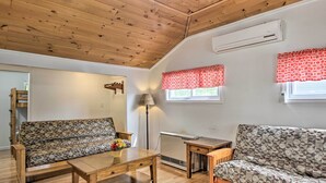 A cozy living room with two sofas, a wooden coffee table, and a radiator. - Homey Laconia Home w/ Private Porch & Grill (Laconia)