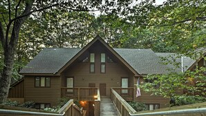 A wooden lodge with a central staircase leading to a front door, surrounded by trees. - Wintergreen Resort Mountain Condo w/ Pool Access! (Nellysford)