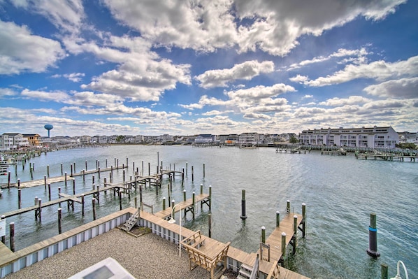 A waterfront area with wooden docks and a water tower in the background.