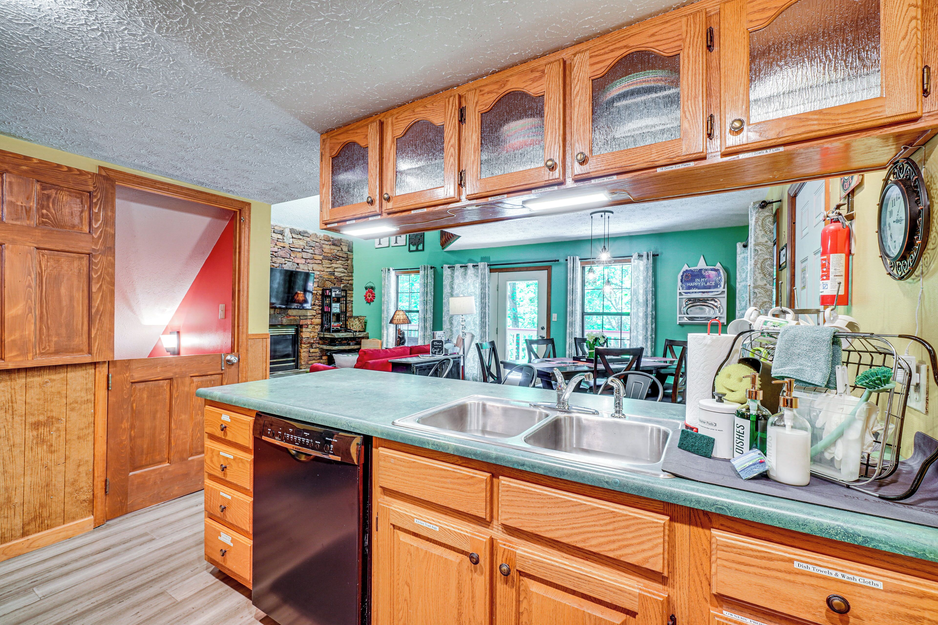 A kitchen with wooden cabinets, a dishwasher, and a sink.