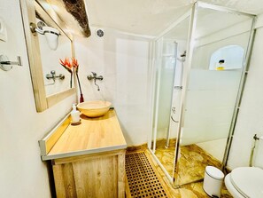 A bathroom with a wooden vanity, a round sink, a glass shower enclosure, and a toilet. - the sea while the legendary country's calm (le beausset)