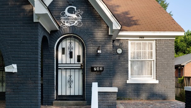 A black brick house with a white door and window, a mailbox, and a street number 743. - Midtown Home Away From Home ShellCrestCorp 743 (Memphis)